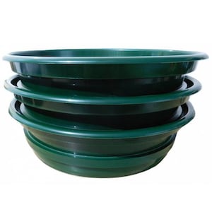 May include: Four green plastic panning bowls stacked on top of each other. The bowls are used for gold panning.