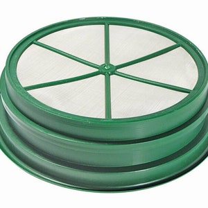 May include: A green plastic sifter with a stainless steel mesh screen. The screen has six spokes radiating from the center.