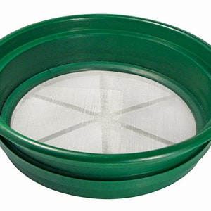 May include: A green plastic sifter with a white mesh screen. The sifter is designed for separating materials by size.