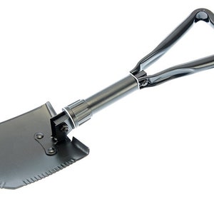 May include: A black folding shovel with a triangular handle. The shovel has a serrated edge and a pointed tip.