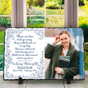 May include: A black slate memorial plaque with a floral design and a photo of a woman. The plaque reads "Those we love don't go away. They walk beside us every day. Unseen, unheard, but always near. Still loved, still missed, and very dear. In Loving Memory Of Rachel Smith June 14, 1996 - January 1, 2024."