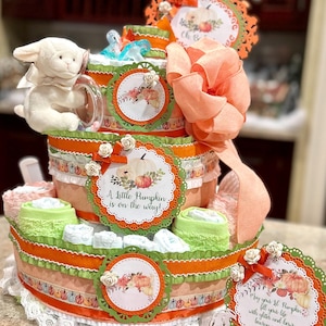 プレミアム4段リトルパンプキンおむつケーキ。ぬいぐるみ、おしゃぶり、ブラシとコームセット、ウォッシュクロス、ケーキサイン、ケーキトッパー付き。