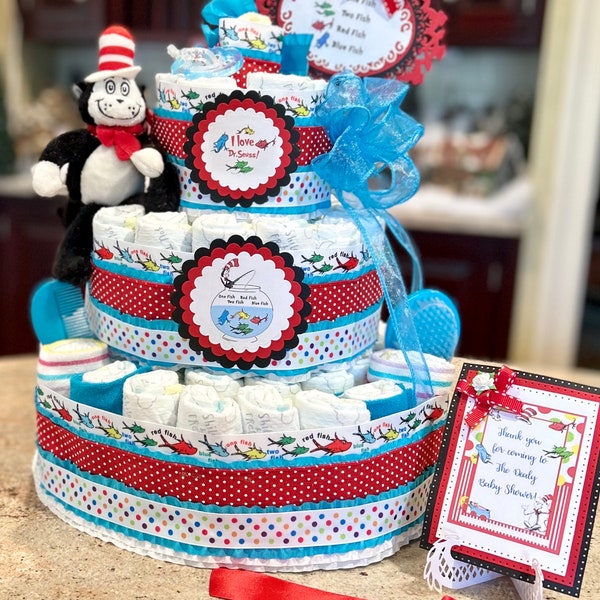 Premium 4 Tier Dr. Seuss Diaper Cake, One Fish Two Fish With Stuffed Cat In The Hat, Brush/Comb Set, Pacifiers, Washcloths and Cake Topper