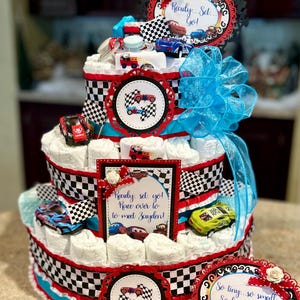 Premium 4 Tier Race Car Diaper Cake With 6 Piece Diecast Race Car Set, Washcloths, Pacifiers, Decorative Signs, Checkered Flags, Cake Topper