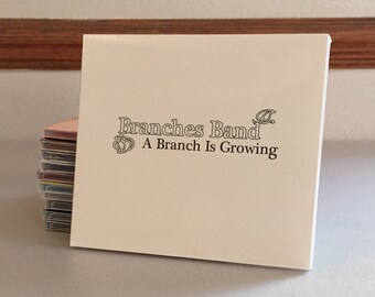 May include: A white CD case with the text "Branches Band" and "A Branch Is Growing" printed on the front.