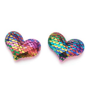 May include: Two rainbow sequin heart-shaped patches. The hearts are made of iridescent sequins in shades of pink, purple, blue, green, yellow, and orange.