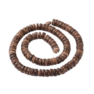 May include: A strand of brown coconut shell beads, arranged in a spiral shape. The beads are approximately 1/2 inch in diameter and have a natural, rustic finish.