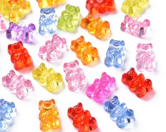 May include: Assortment of colorful gummy bear shaped candies in various colors, including red, orange, yellow, green, blue, purple, and pink.