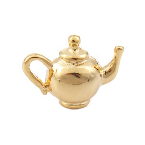 May include: A gold-colored teapot charm with a rounded body and a spout. The charm is small and detailed, perfect for adding a touch of whimsy to a bracelet or necklace.
