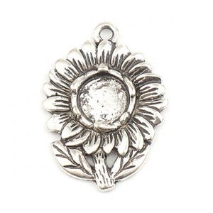 May include: A silver-colored sunflower pendant with a loop at the top for hanging. The pendant features detailed petals, leaves, and a central setting. The design is intricate and has a vintage or antique aesthetic.