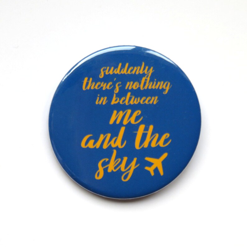 May include: A blue round button with the text "suddenly there's nothing in between me and the sky" in yellow with a small airplane icon.