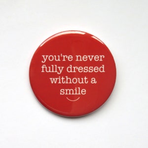 Annie The Musical inspired button/badge or magnet  - "You're never fully dressed without a smile"