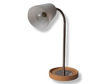 May include: A brown and black desk lamp with a white shade and a flexible arm. The lamp has a wooden base.