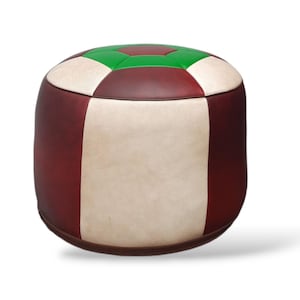 May include: A round, multi-colored leather ottoman with a white, green, and burgundy color scheme. The ottoman is made of leather and has a stitched design.