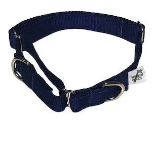 May include: A navy blue dog collar with metal hardware. The collar is made of durable fabric and features a tag with the text "WAGGING GREEN". The collar is designed for comfort and safety.