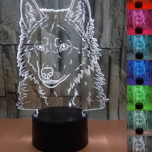 May include: A white 3D printed wolf head night light on a black base. The light is illuminated in white, and there are multiple color options shown in the background.