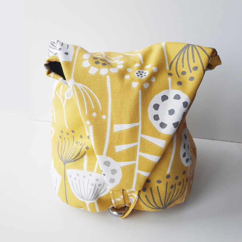 A peg bag with a conical shape.  Great for storing clothespins, craft items etc. A large carabiner clips to the washing line. To store, the top flips over and the carabiner clips into a loop to close.