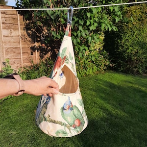 A peg bag with a conical shape.  Great for storing clothespins, craft items etc. A large carabiner clips to the washing line. To store, the top flips over and the carabiner clips into a loop to close.