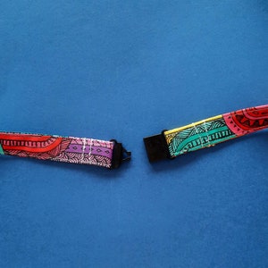 A fun fabric lanyard with a colourful funky rainbow design. With a black breakaway clasp.
