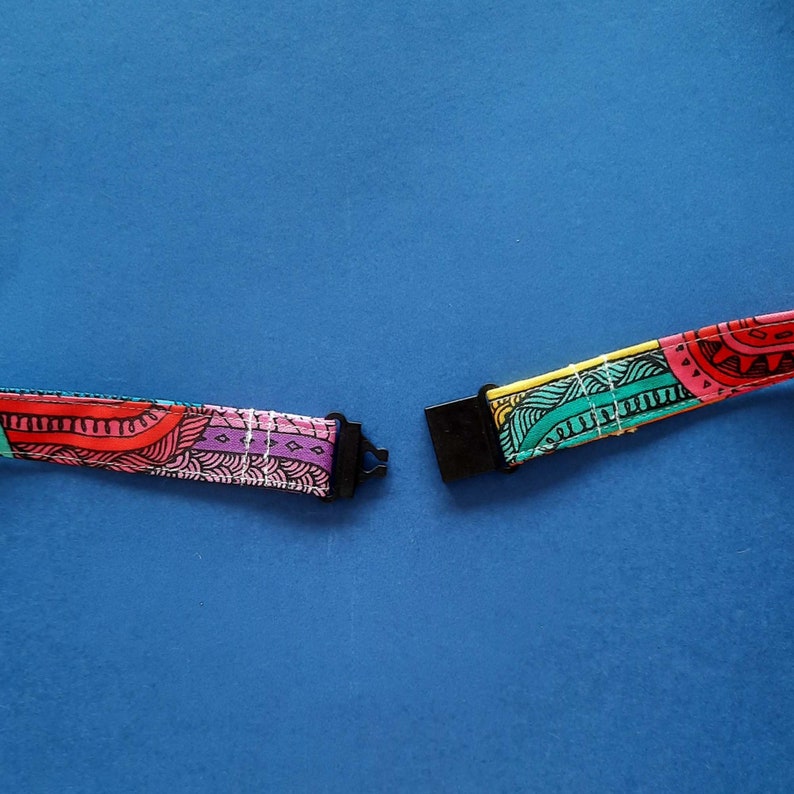 A fun fabric lanyard with a colourful funky rainbow design. With a black breakaway clasp.