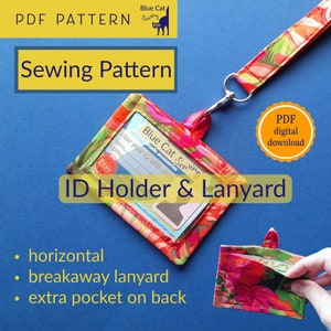May include: A PDF sewing pattern for a horizontal ID holder and lanyard with a breakaway lanyard and an extra pocket on the back. The pattern features a colorful floral design with a blue cat logo.