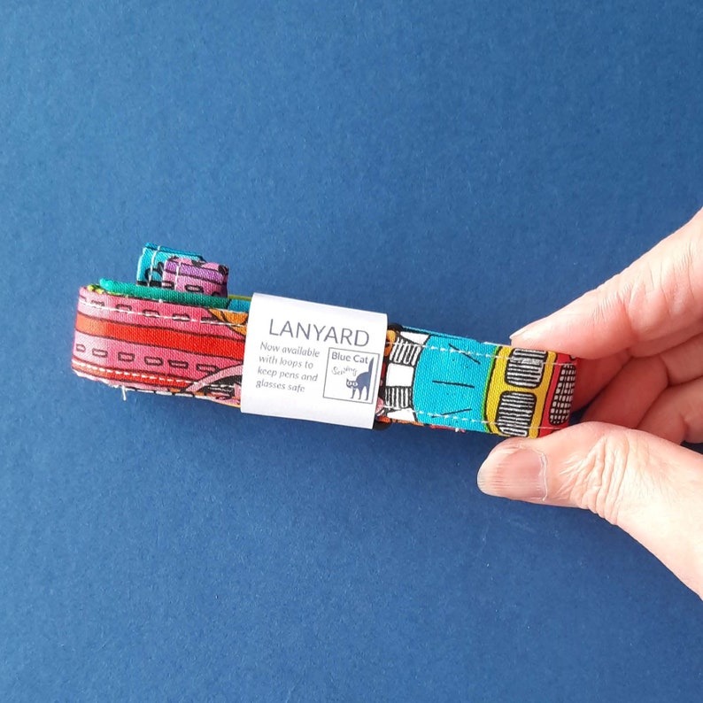 A fun fabric lanyard with a colourful funky rainbow design. With a paper wrap to keep it folded for packaging.