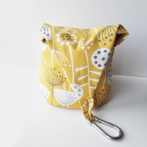 A peg bag with a conical shape.  Great for storing clothespins, craft items etc. A large carabiner clips to the washing line. To store, the top flips over and the carabiner clips into a loop to close.