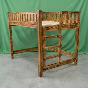 May include: A loft bed frame constructed from dark stained wood with a visible grain pattern. The structure features a slatted base, a protective railing around the upper perimeter, and an integrated ladder on the side for access.