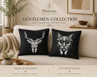 May include: Two square black throw pillows featuring white graphic illustrations. One pillow displays a deer head wearing a suit and tie, while the other shows a cat wearing glasses, a suit, and a tie. The text Mineste Collection Gentlemen Collection is visible.