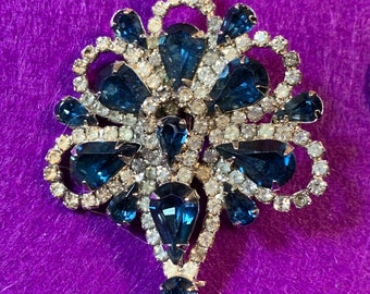 Rhinestone beauty with unique Fleur de Lis like shape featuring blue and white stones