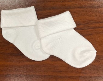 May include: A pair of white baby socks with a folded cuff.
