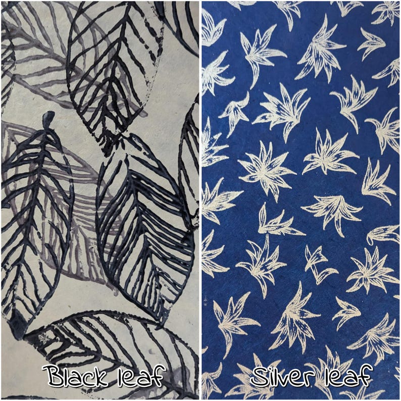 May include: Two fabric samples with leaf patterns. One features black leaves on a light background, the other has silver leaves on a dark blue background. The text "Black leaf" and "Silver leaf" are at the bottom.