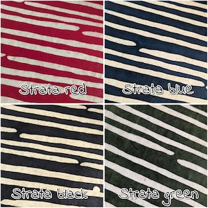May include: Four fabric swatches with diagonal white stripes on red, blue, black, and green backgrounds. Each swatch is labeled with the text "Strata" followed by the color name. The fabrics have a textured appearance.