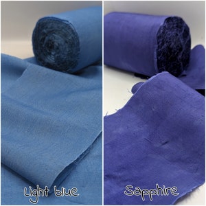 May include: Two rolls of fabric, one light blue and one sapphire, are displayed. The light blue fabric is unrolled, with the text "Light blue" below it. The sapphire fabric is also unrolled, with the text "Sapphire" below it.