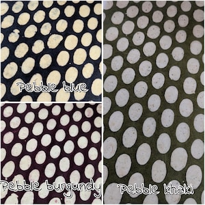 May include: A collage of four fabric swatches with a pebble pattern. The colors are pebble blue, pebble burgundy, and pebble khaki. Each swatch has a dark background with light-colored oval shapes evenly spaced across the surface. The text "Pebble blue", "Pebble burgundy", and "Pebble khaki" are written on the swatches.