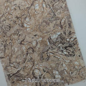 May include: A sheet of handmade paper with a textured surface. The paper features a mix of brown tones, with the text "Mixed browns" at the bottom.