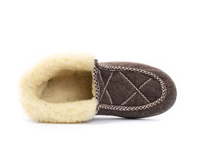 May include: Brown quilted slipper with a soft, white fleece lining. The slipper has a decorative stitch detail around the edge.