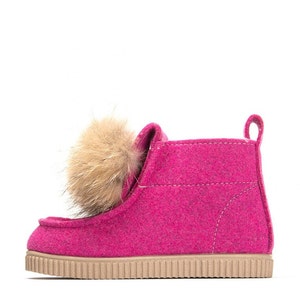 May include: Pink felt ankle boots with a faux fur pom-pom on the top.