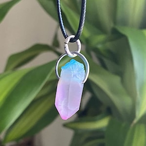 May include: A silver chain necklace with a pink, blue, and white crystal pendant.