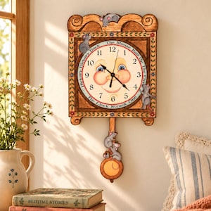 May include: A rectangular wall clock with a wooden frame featuring painted mice and floral accents. The clock face has a smiling human face, black hands, and the text Hickory Dickory Dock The Mouse Ran Up The Clock The Clock Struck One.