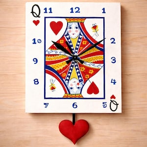 May include: A white wall clock featuring the Queen of Hearts playing card design. The clock face has blue numerals and black clock hands. A red heart-shaped pendulum hangs below. The clock is a unique decorative item.