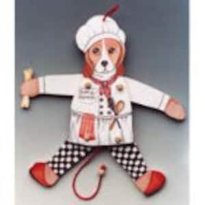 May include: A wooden puppet of a beagle dog dressed as a chef. The puppet has a white chef's hat, a white chef's jacket, a red and white checkered apron, and black and white checkered pants. The puppet is holding a wooden bone in one hand and a wooden spoon in the other.