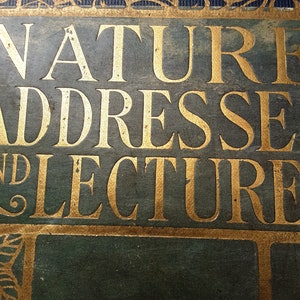 May include: A vintage book cover with the title "Nature Addresses and Lectures" in gold lettering on a dark green background.