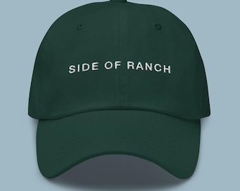 May include: A dark green baseball cap with white embroidered text that reads "SIDE OF RANCH".