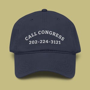 May include: Navy blue baseball cap with the embroidered text "CALL CONGRESS" and the phone number 202-224-3121 in white. The cap has a curved brim and a classic six-panel design.