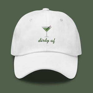 May include: White baseball cap with an embroidered green martini glass and the text "dirty af".