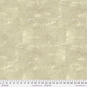 May include: A beige fabric with a marbled appearance and subtle white veining. The fabric has a textured look, with faint, blurred text visible throughout. A ruler is at the bottom, marked in inches, showing measurements up to 24 inches.