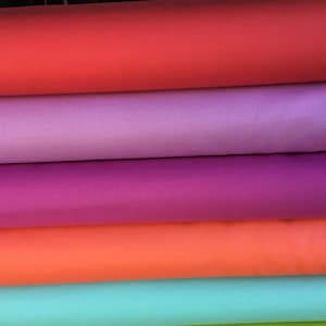 May include: Five rolls of fabric in different colors: red, purple, pink, orange, and turquoise.