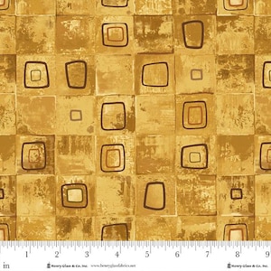 May include: Fabric with a repeating pattern of squares in shades of gold and brown. Each square contains a smaller square or rectangle, outlined in dark brown. The fabric has a textured, aged appearance, with a ruler at the bottom.
