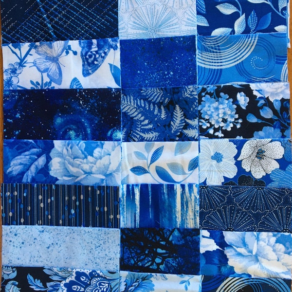 Charm Pack of blue and white fabrics from various manufacturers. 26 different Fat Quarters repeated twice.